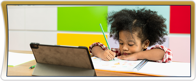 Young black girl focused on her school work at a desk