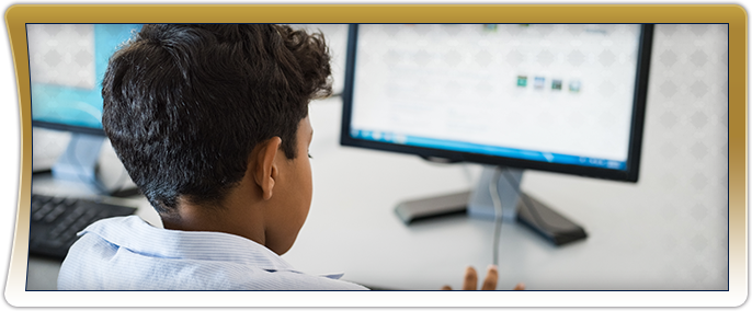 Male student using a desktop computer