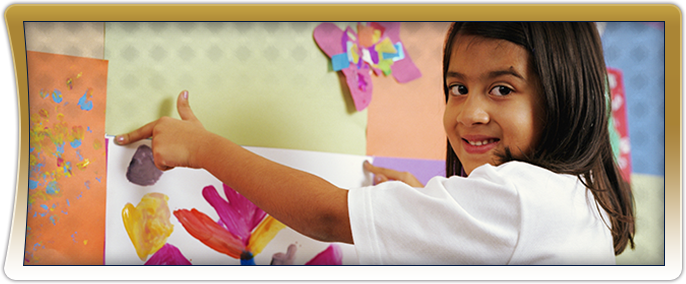 Female student hanging up artwork