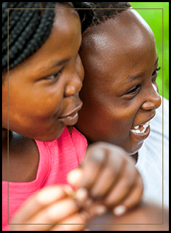 Two students laughing together outside